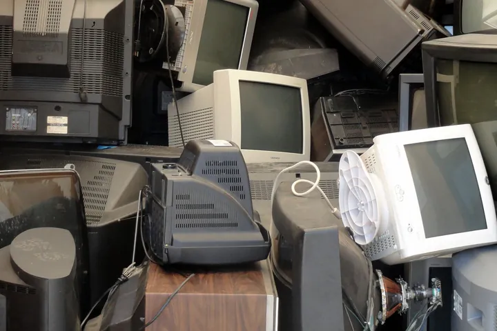 A pile of discarded monitors and electronics