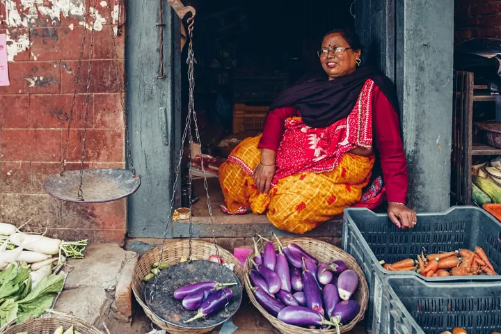 A woman running her own vegetable shop